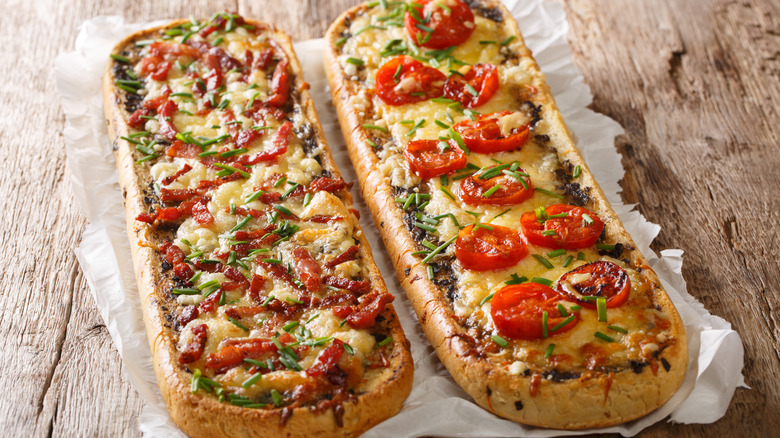 two zapiekanki pizza breads with different toppings