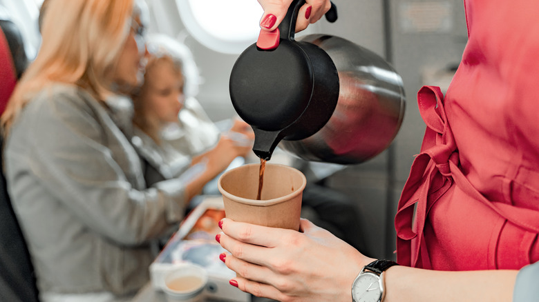 stewardess pouring coffee on flight