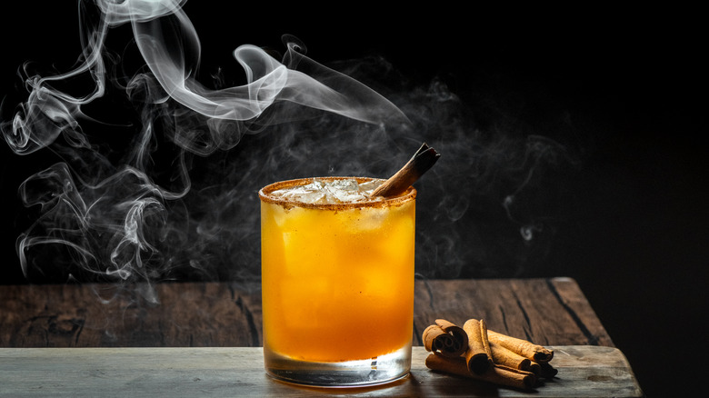 cocktail with smoked cinnamon sticks