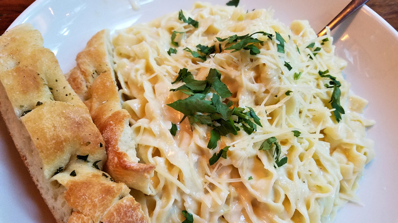 Fettuccine Alfredo pictured with a side of bread