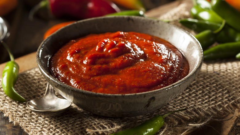 Bowl of sriracha with green peppers