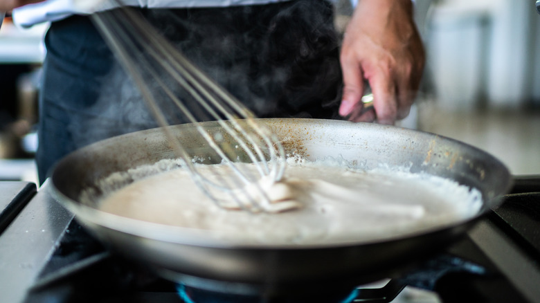 whisking pan of beurre blanc sauce