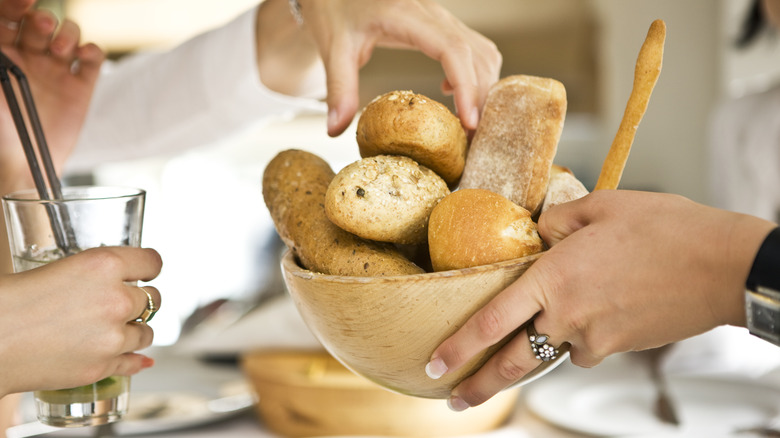 Diners sharing restaurant bread basket