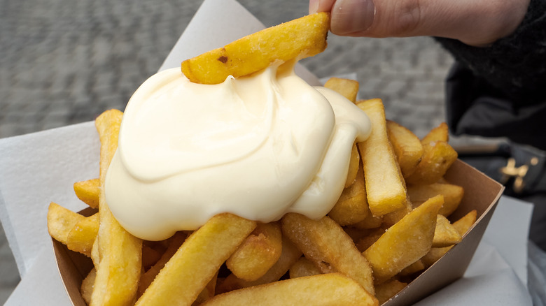 Dipping fries in mayo