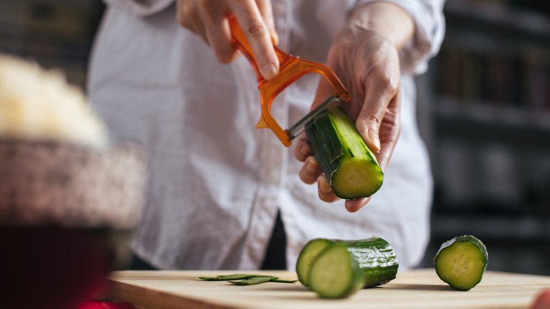 Chef peeling a cucumber