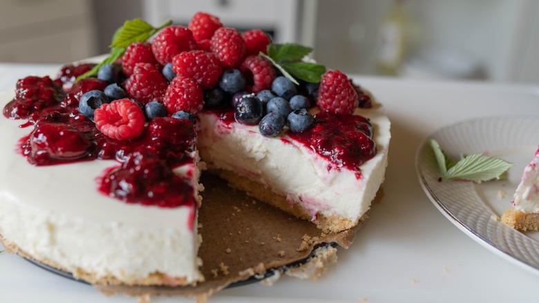 No bake cheesecake piled with fresh berries and mint leaves