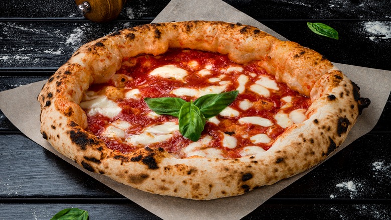 Margherita pizza on black table