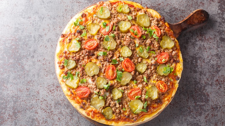 Cheeseburger pizza on wooden tray