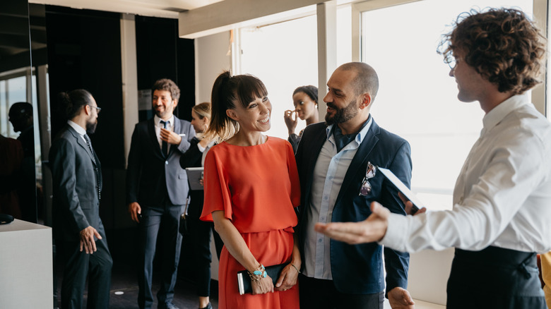 smiling couple entering restaurant