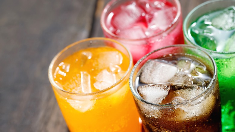 glasses of soda in different flavors with ice