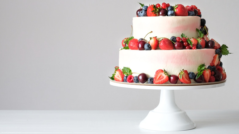 A tiered cake with fruit decorations