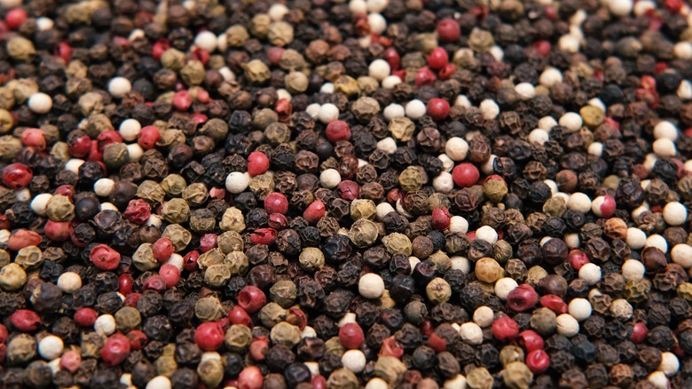 mixed pile of various peppercorns