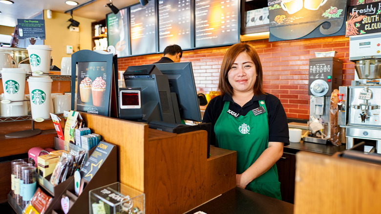 Starbucks barista behind register