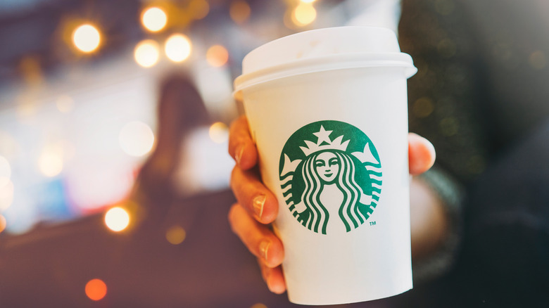 Person holding Starbucks cup