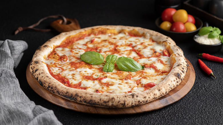 Pizza with basil, tomato and cheese