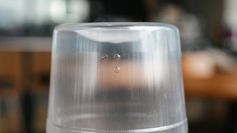 Close-up of raised dots on the bottom of a Starbucks venti cold cup