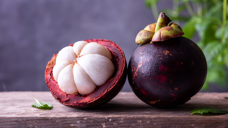 halved and whole mangosteen