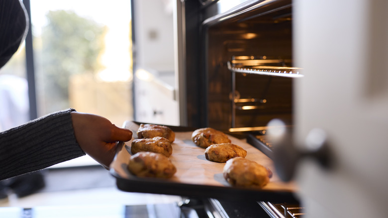 Putting cookies in oven