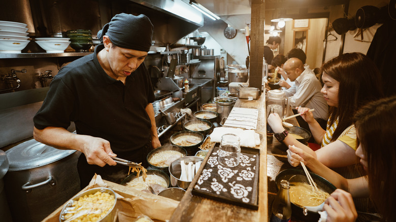 a chef making ramen in a Japanese shop