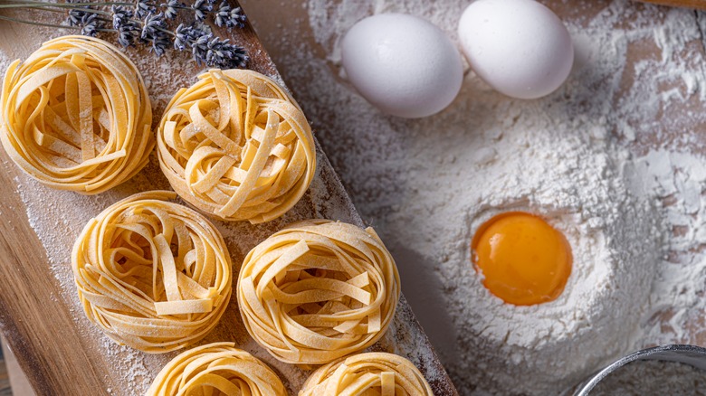 fresh fettuccine on a wooden board