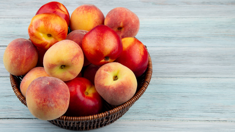 nectarines and peaches in wooden basket