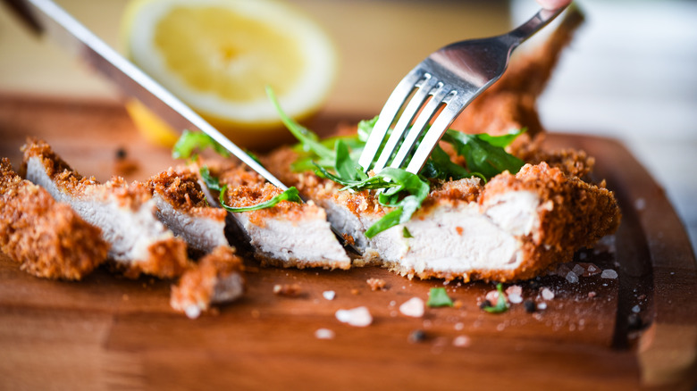 Person eating Panko fried chicken