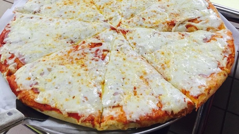 Cheese pizza on metal dish