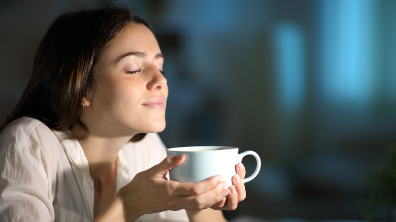 A woman enjoying some coffee.