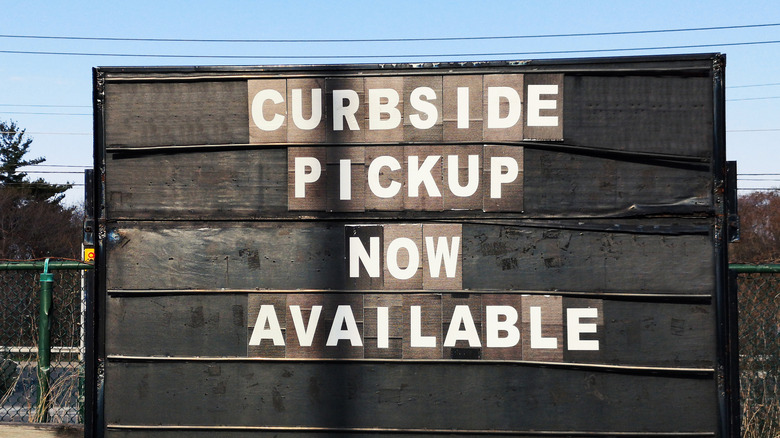 sign reading "Curb-side delivery now available"