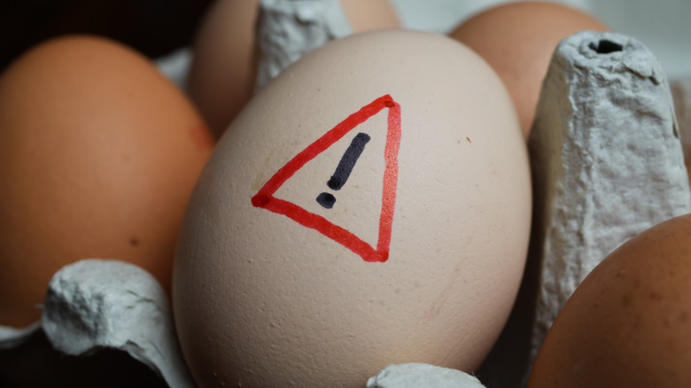 Egg with a warning sign on it 