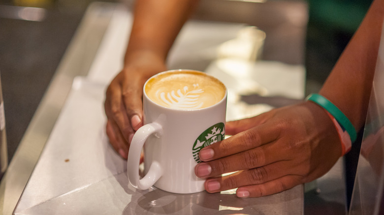 Starbucks cup holding a latte