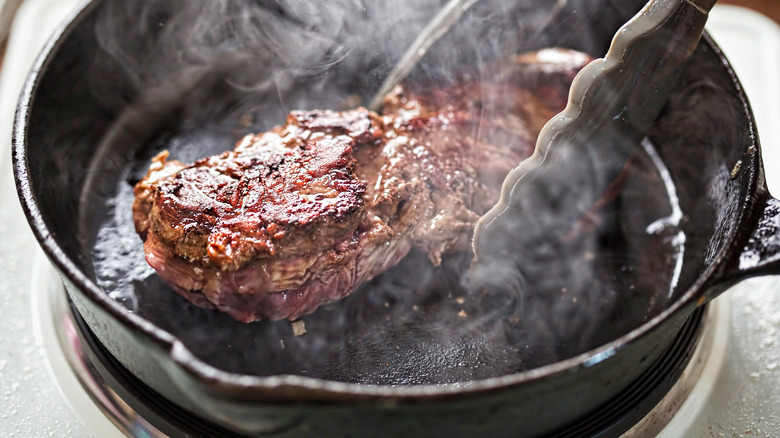 Steak frying in a pan 