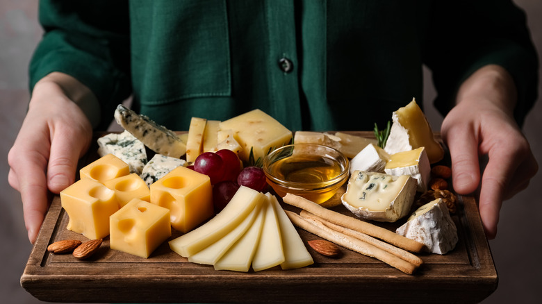 Person holding cheese platter