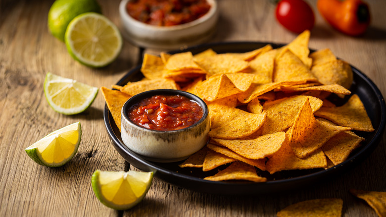 Tortilla chips with salsa and limes