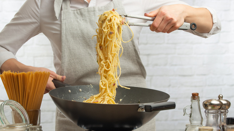 Chef cooking pasta over 