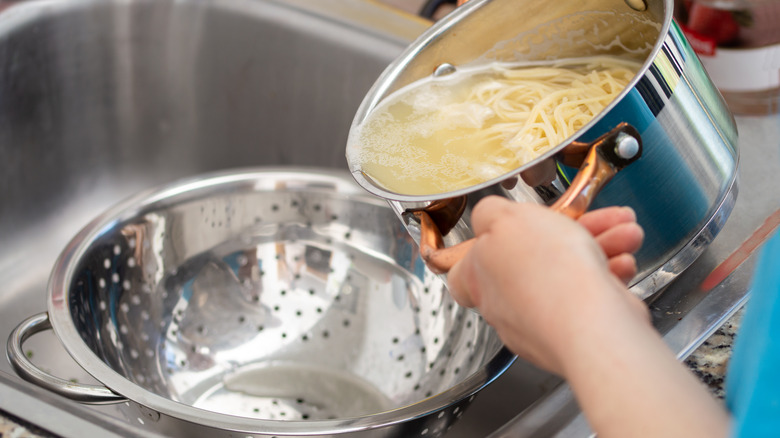 Pouring out starchy pasta water