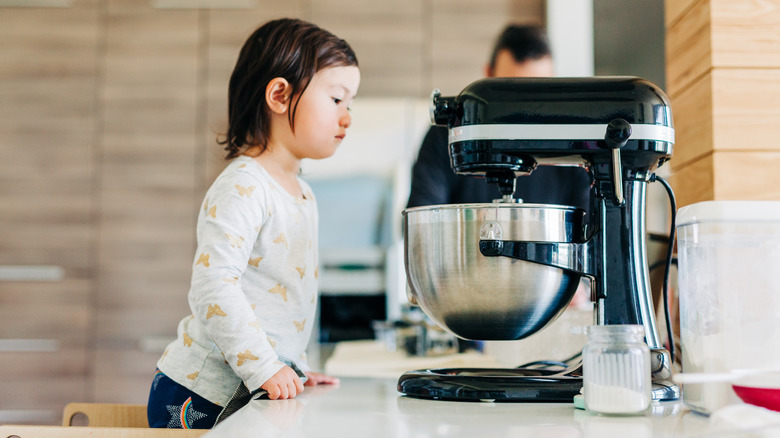 small child watching mixer spin