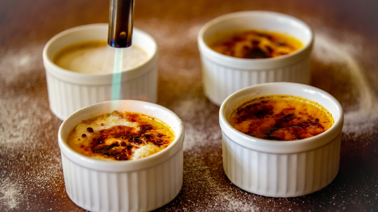 Sugar being caramelized on creme brulee