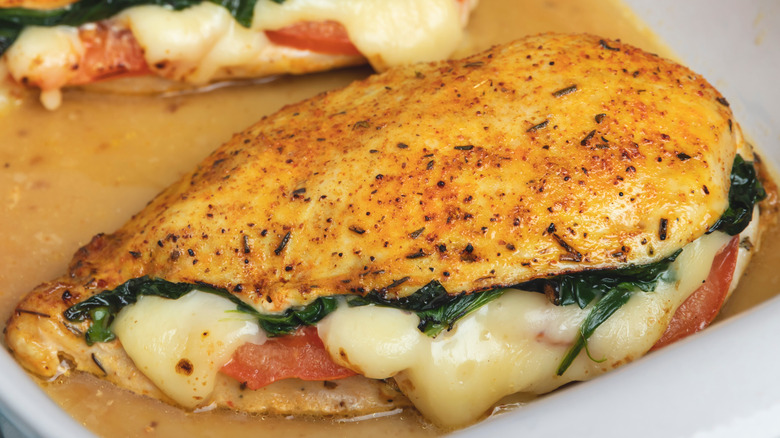 Stuffed chicken breast with cheese, tomatoes, and spinach