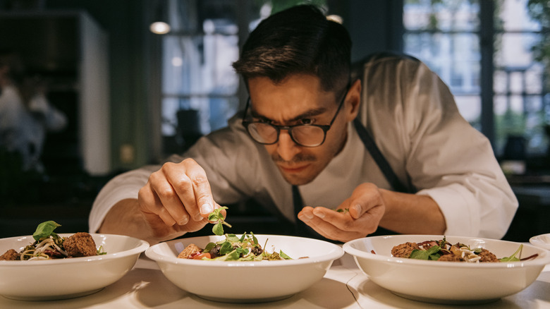 Chef concentrating while plating food