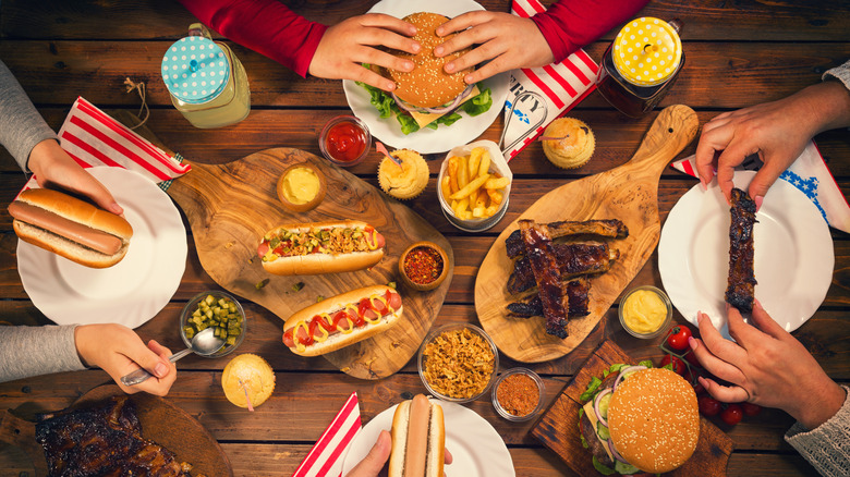 plates of hot dogs, burgers, ribs