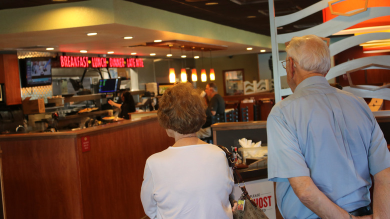 couple waiting inside Denny's