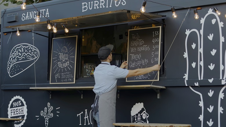 food truck owner hanging menu