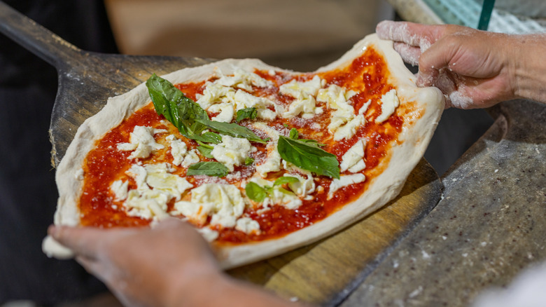 Pizza margherita on a peel