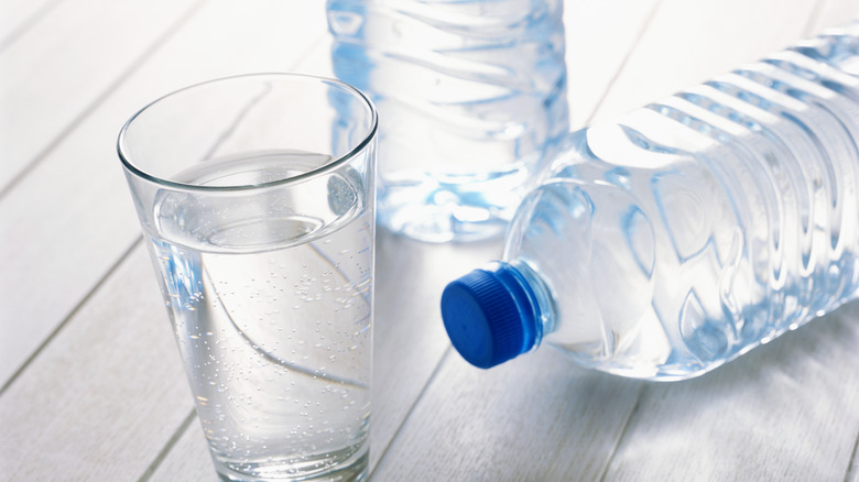 glass and bottles of water