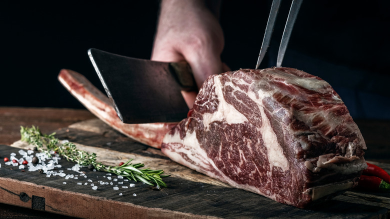 cutting dry aged tomahawk steak