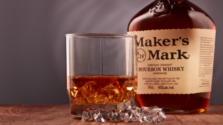 Maker's Mark whisky in a glass next to bottle