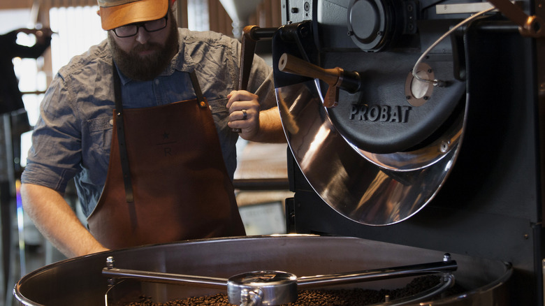 man roasting peaberry coffee