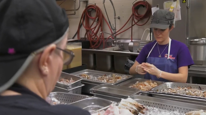 Woman prepping rock shrimp