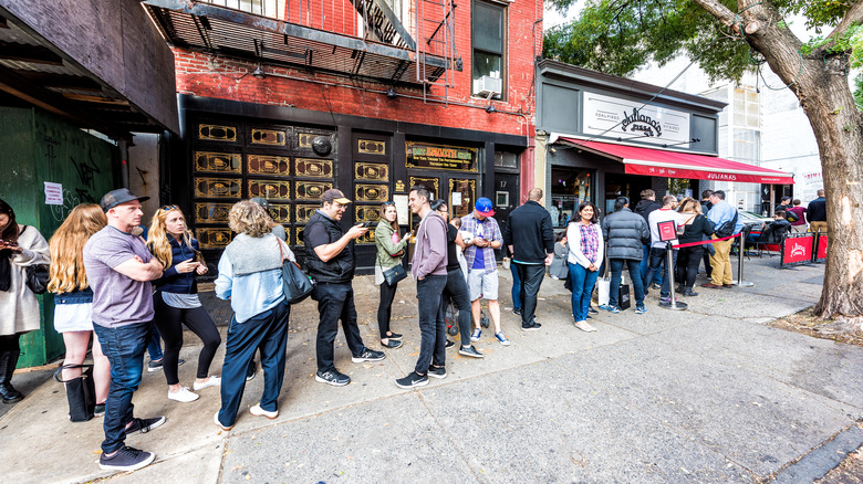 A long queue at a pizza restaurant